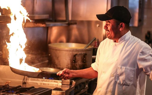 Chefs plating dishes in the open kitchen at Ostler Kitchen Co